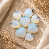 Opalite mini heart pendants displayed on a natural stone surface