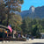 Idyllwild street with mountains in the background, American flag and rainbow flag visible.