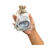 A hand holding a Intentions Bracelet Set - 8mm Water bracelet set of 3 with Lapis, Clear Quartz, and Amazonite on hand