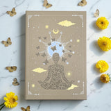 Earths Elements Intention Journal on a marble surface with flowers and butterflies.