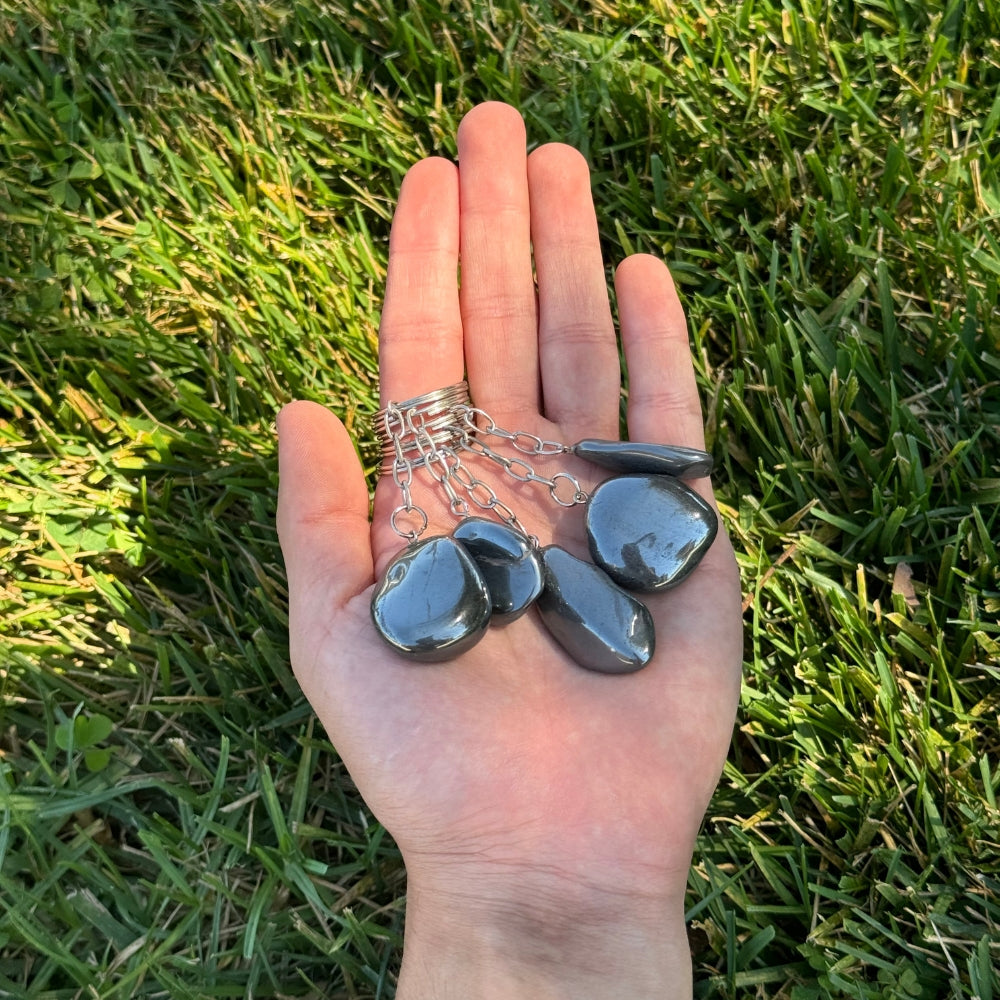 Hand holding five Hematite keychains