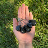 Three Black Obsidian keychains on a grassy backgroud