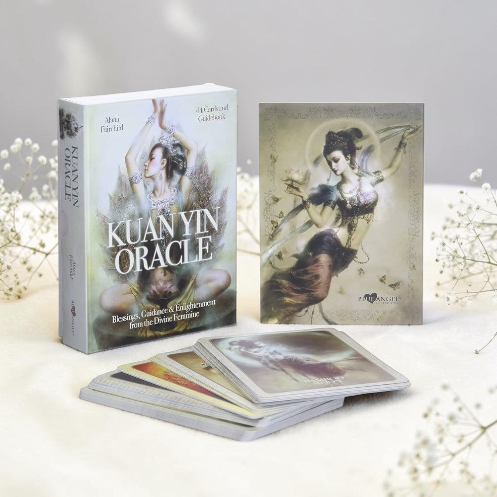 Kuan Yin Oracle card set with book on a light background