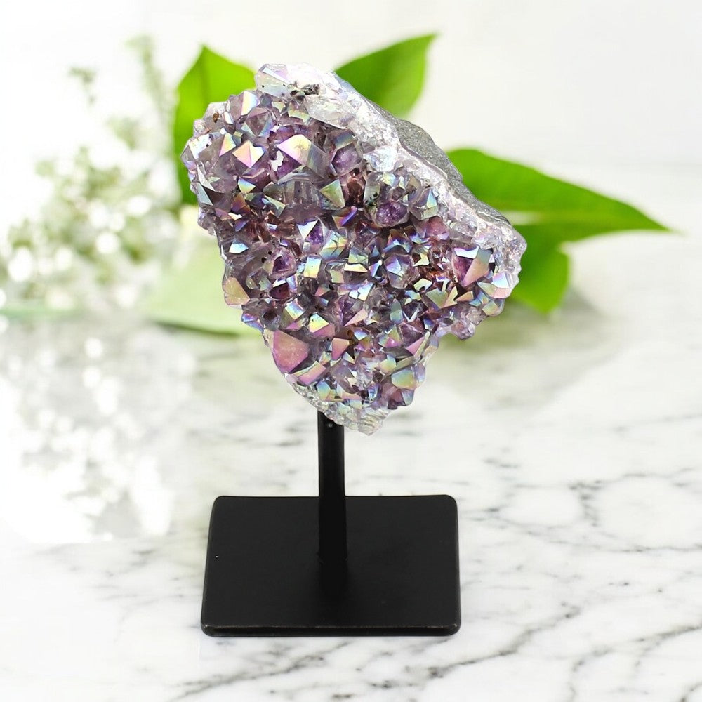 Lavender Aura on Stand on a black stand with a marble background