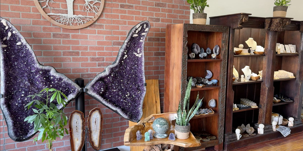 Inside the store showing a large amethyst butterfly and displays with crystals and jewelry
