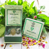 Money Magnet crystal healing collection packaging with green leaves and flowers in the background