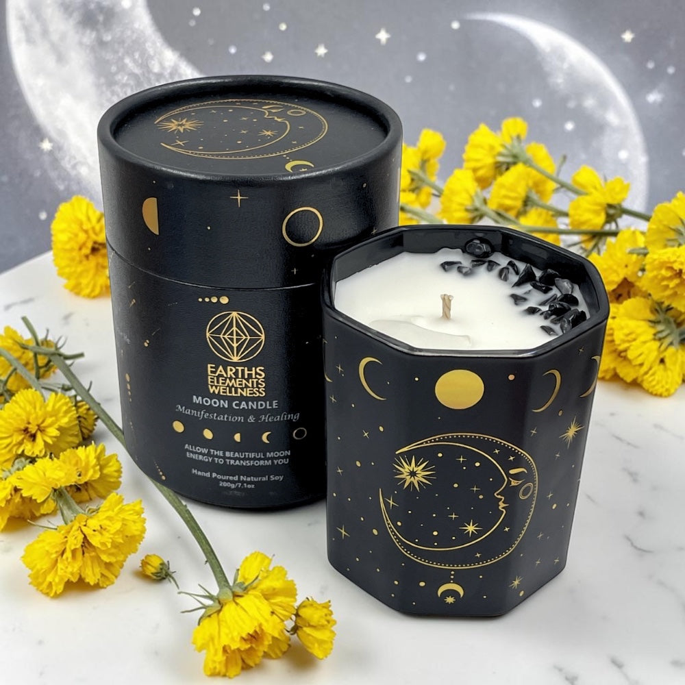 Hexagonal moon candle with decorative lid on a marble surface with yellow flowers