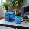 Magical moon mug with packaging on a table in a cozy living room setting