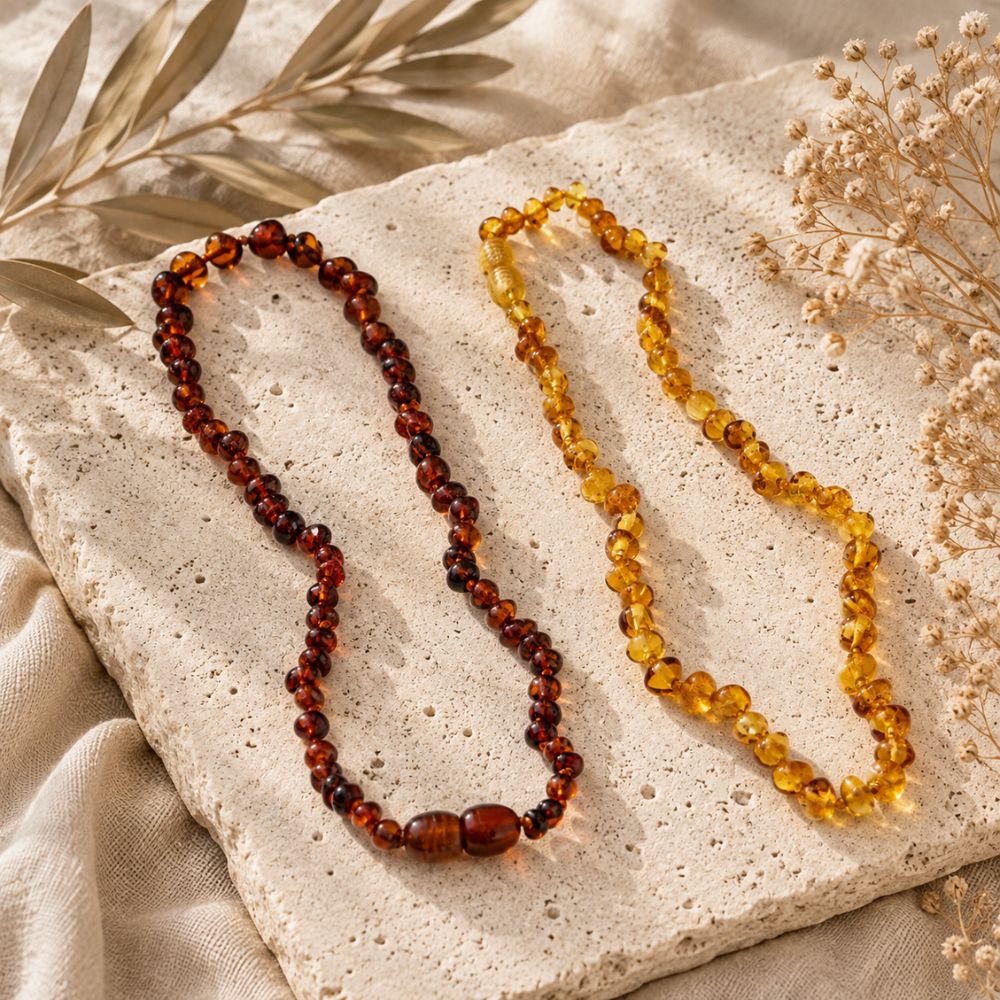 Natural amber baby teething necklaces in honey and cognac amber with polished round beads.