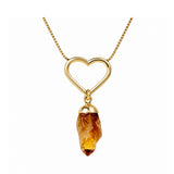 Gold pendant with a citrine gemstone on a white background