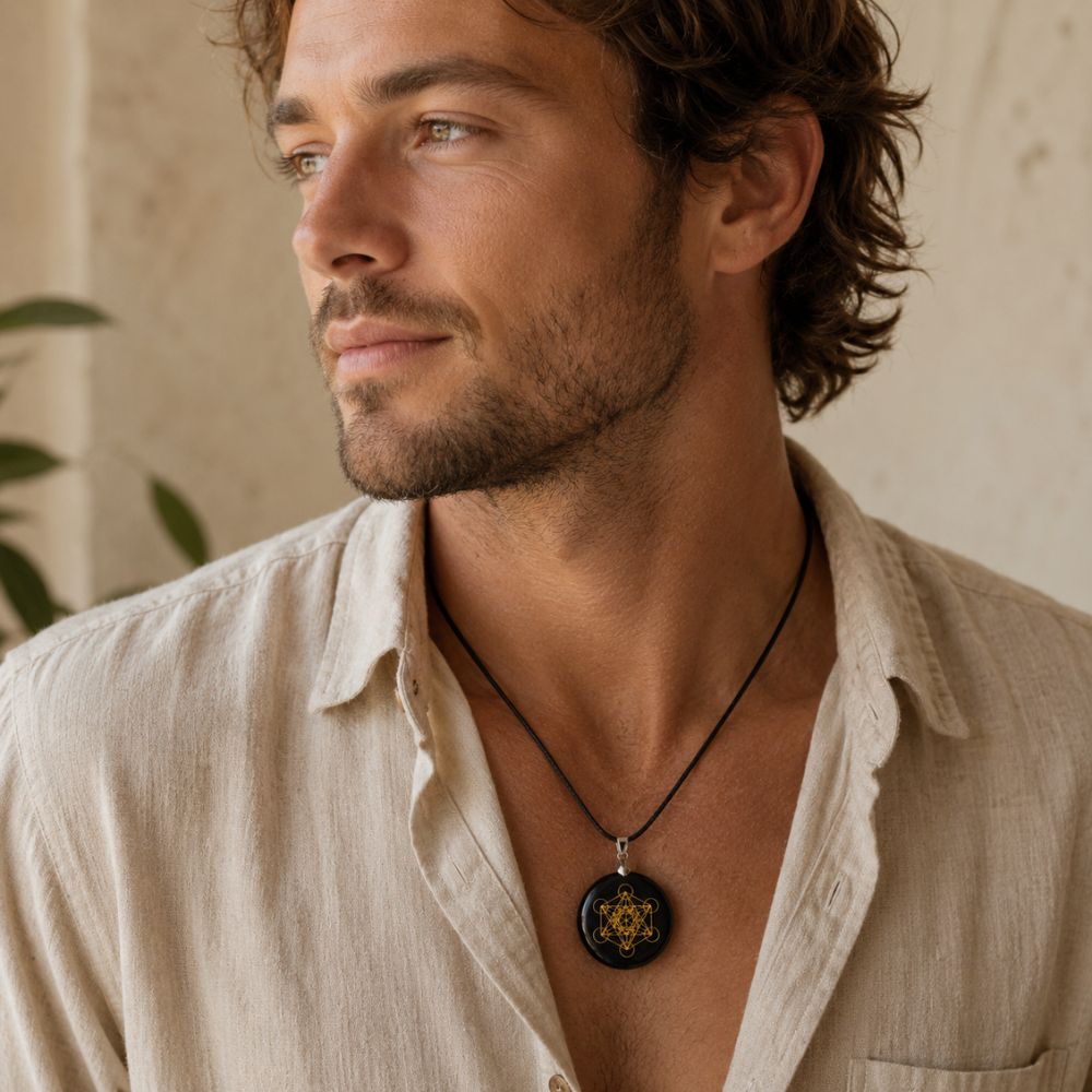 Man wearing a Black Obsidian Metatron Pendant on a delicate silver chain with a relaxed white linen blouse.