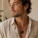Man wearing a Black Obsidian Metatron Pendant on a delicate silver chain with a relaxed white linen blouse.