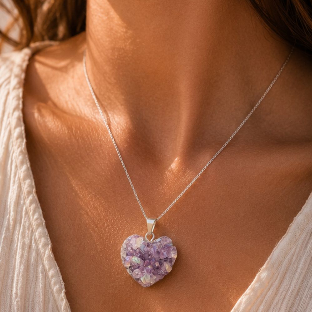 Necklace with a purple heart-shaped pendant worn by a person