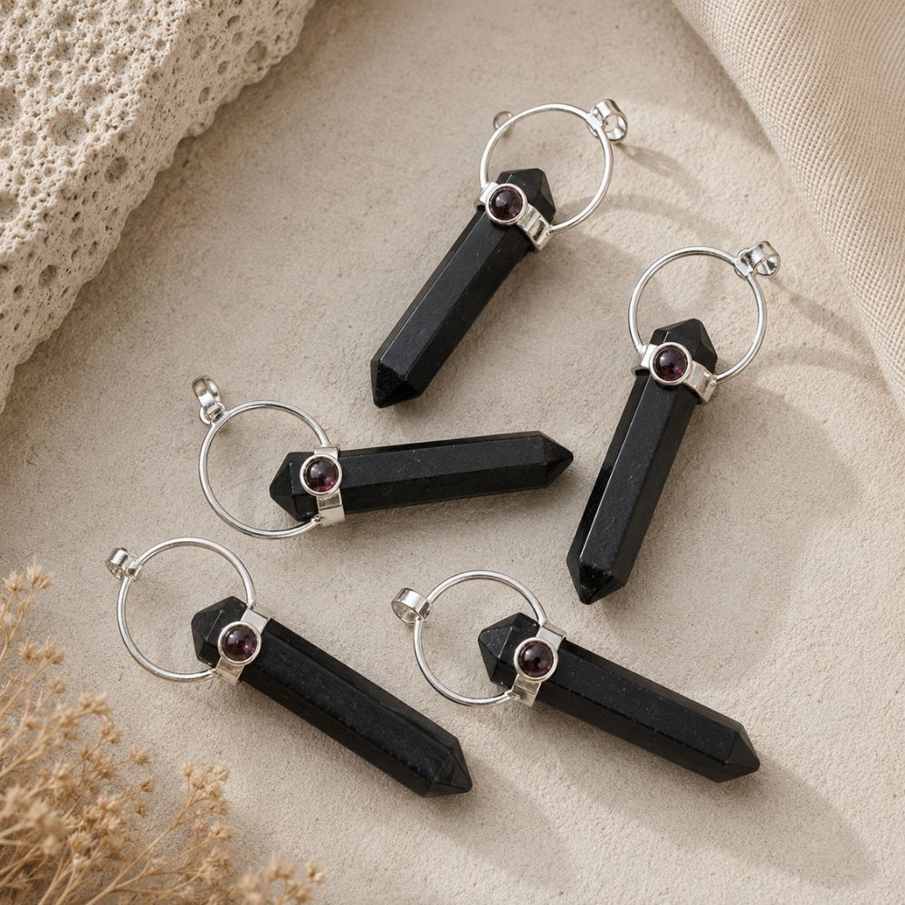 Shungite point pendant with Garnet accent on a silver bail and chain.