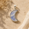 Rainbow moonstone crescent moon sterling silver pendant.