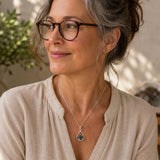 Woman wearing a Raw Blue Apatite silver teardrop pendant on a delicate chain, photographed in soft natural light with a relaxed, everyday style.