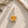 Raw Citrine Silver Teardrop Pendant with natural rough citrine crystal in an open sterling silver setting.