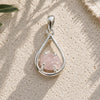 Raw Rose Quartz Silver Teardrop Pendant with a natural rough rose quartz crystal in an open sterling silver setting.