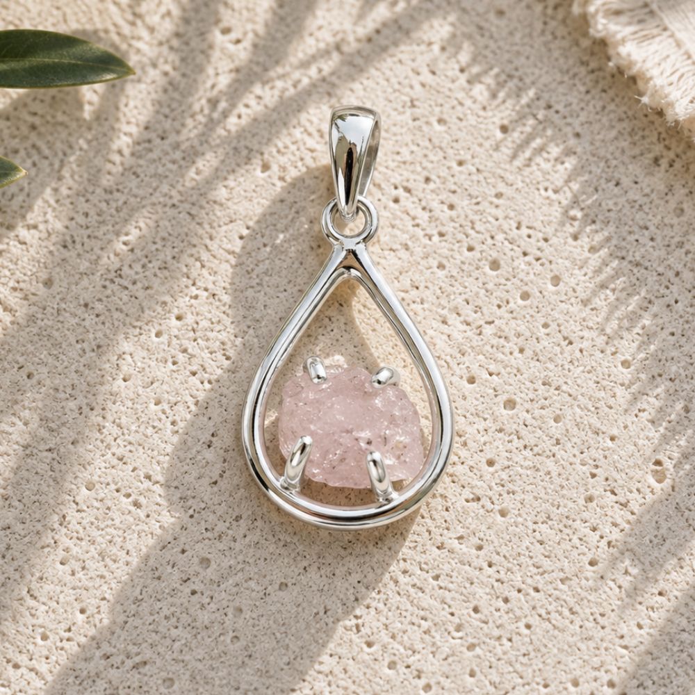 Raw Rose Quartz Silver Teardrop Pendant with a natural rough rose quartz crystal in an open sterling silver setting.