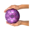 Purple metal tongue drum held in a hand against a white background