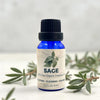 Bottle of Sage essential oil with a label on a light background