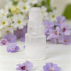 White selenite tower lamp with purple flowers in the background