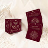Red card deck with 'Spells' packaging on a soft beige background