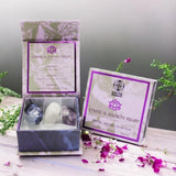 Stress and anxiety relief crystal set with packaging on a wooden surface with flowers.