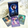 Zodiac Oracle cards with a box on a white surface with flowers