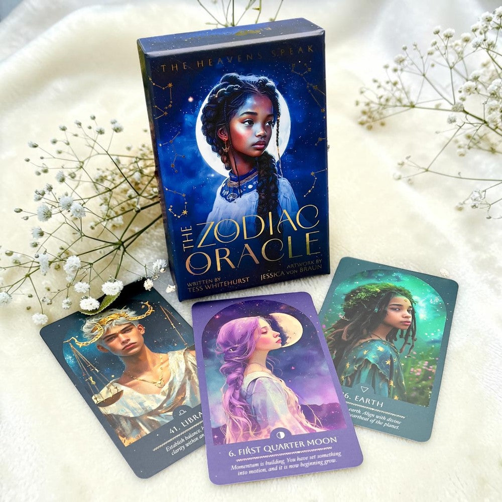 Zodiac Oracle cards with a box on a white surface with flowers