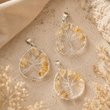  Citrine Tree of Life pendants with natural citrine gemstone chips and silver wire tree designs on a textured stone background.