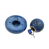 A blue ceramic smoking pipe set on a white background, showing the round base on the left and the perforated spherical top with an attached blue and black water pump on the right.