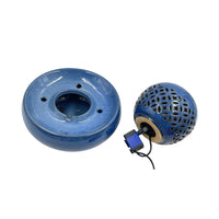 A blue ceramic smoking pipe set on a white background, showing the round base on the left and the perforated spherical top with an attached blue and black water pump on the right.