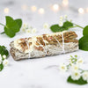 Bundled sage with white twine on a light background with green leaves and flowers.
