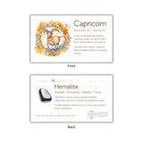 Card with Capricorn zodiac sign and hematite stone on a white background