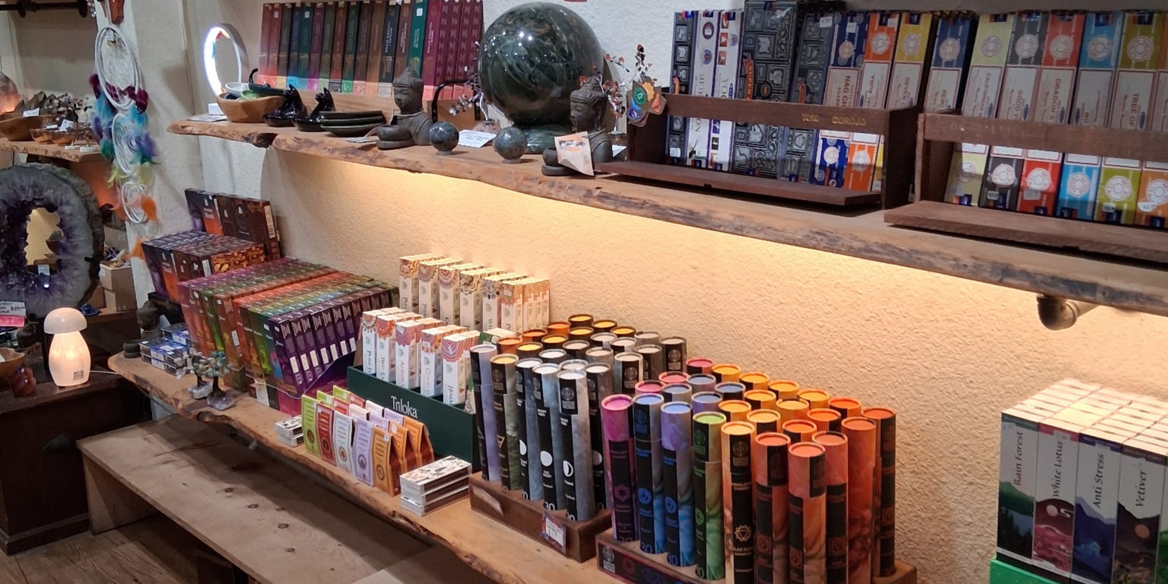 Display of incense items in a store with a counter and shelves.