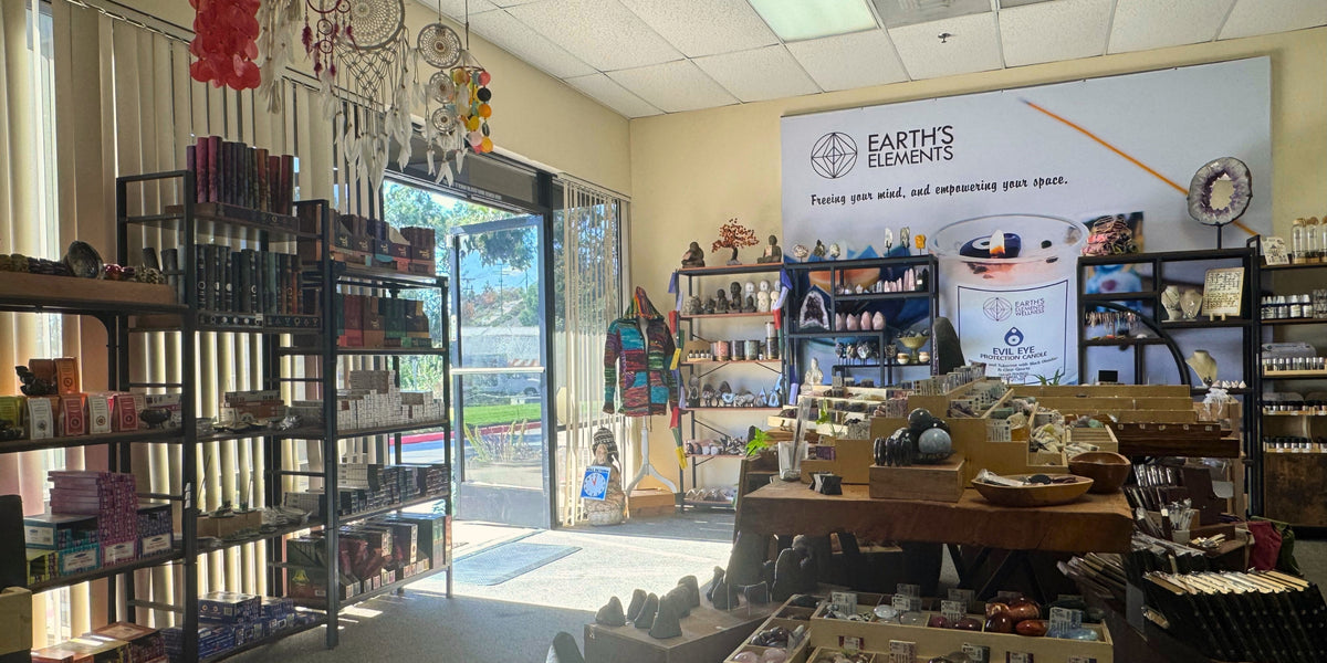 Store interior with shelves, products, and a banner for 'Earth's Elements'.