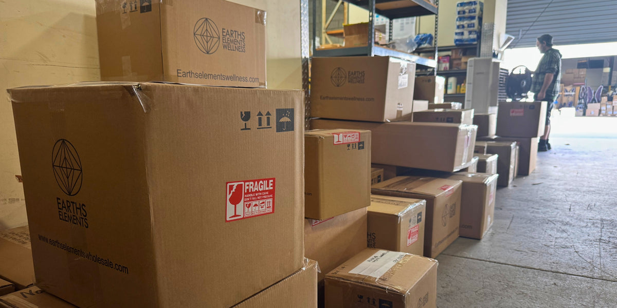 Stack of cardboard boxes with 'Fragile' labels in an outdoor setting.