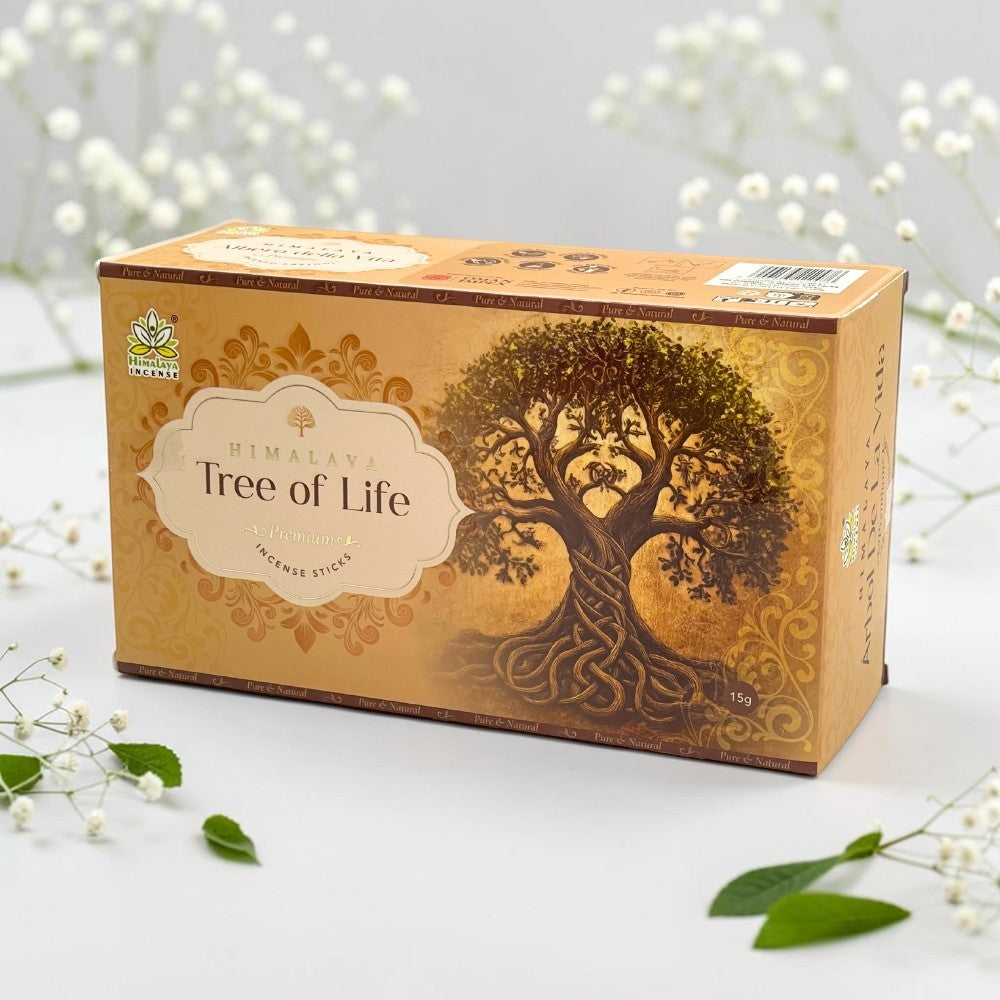 A box of Himalayan Tree of Life incense sticks, featuring a golden-brown design with an illustration of a tree of life and white flowers arranged around it on a white surface.