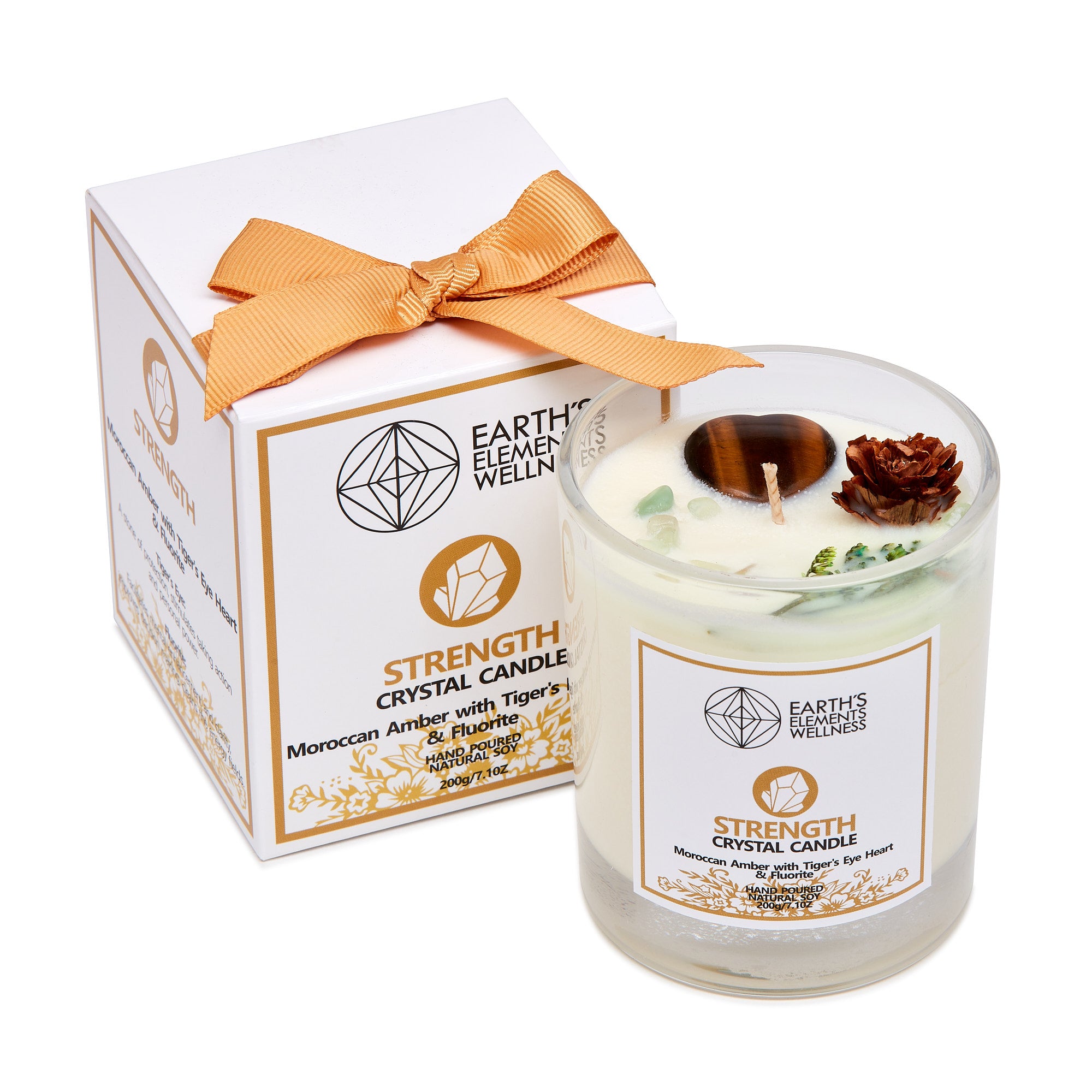 A Strength Crystal Candle by Earth's Elements, showing a white candle jar with a clear glass lid, adorned with a orange ribbon bow. The candle has organic herbs and crystals, and is labeled for meditation, attraction, and healing.